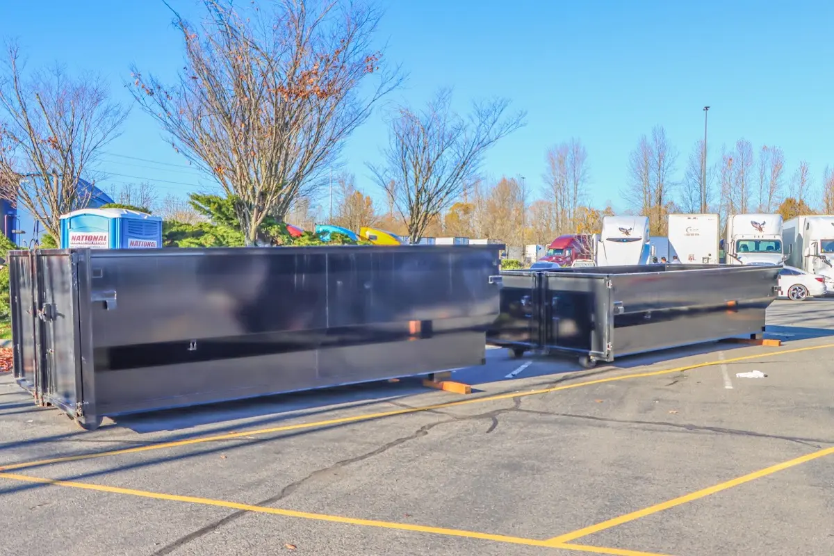Professional dumpster rental service with roll-off container on residential driveway in Cooper